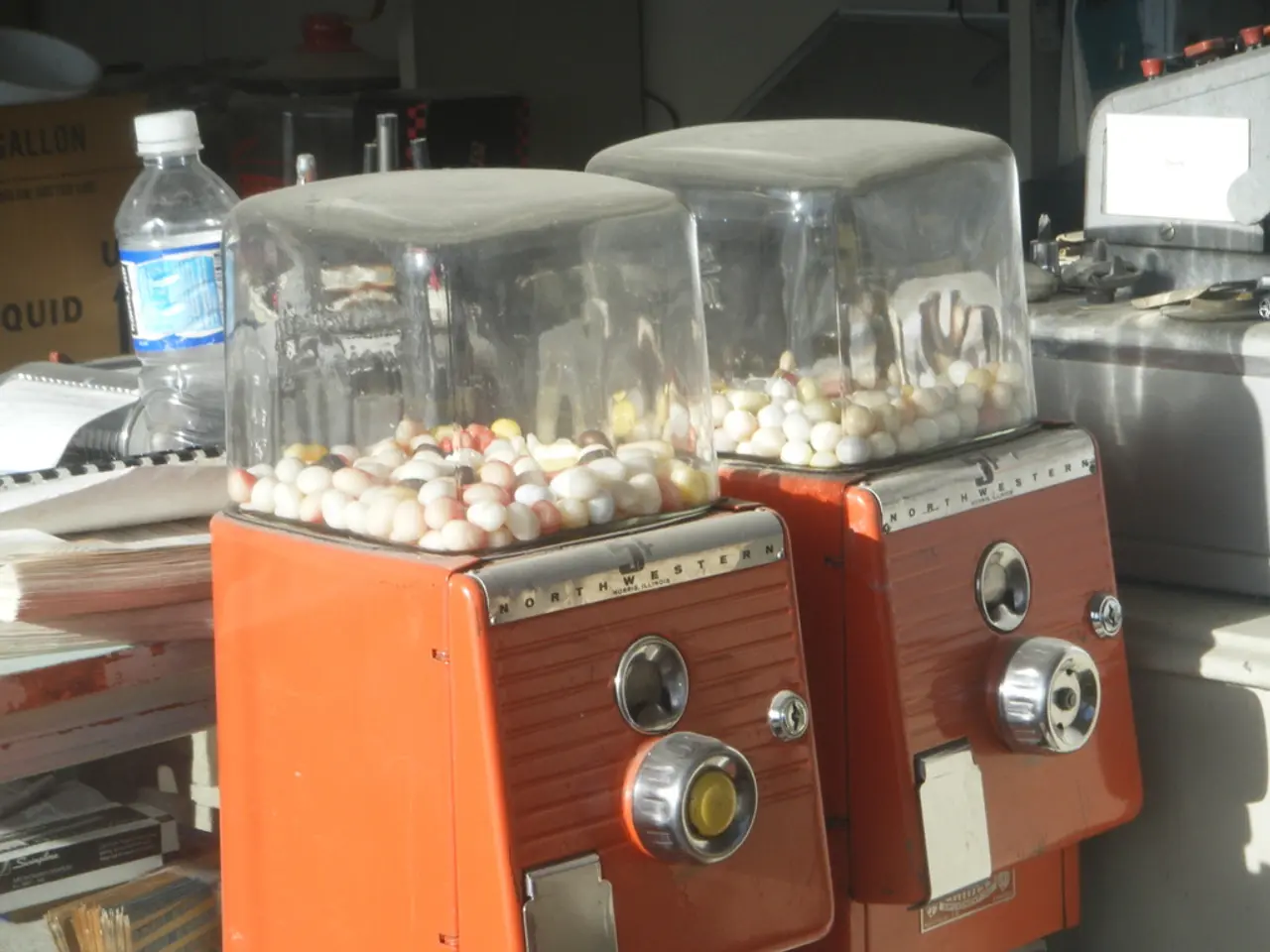 In this picture there are two machines in which some candies were placed. In the background there...