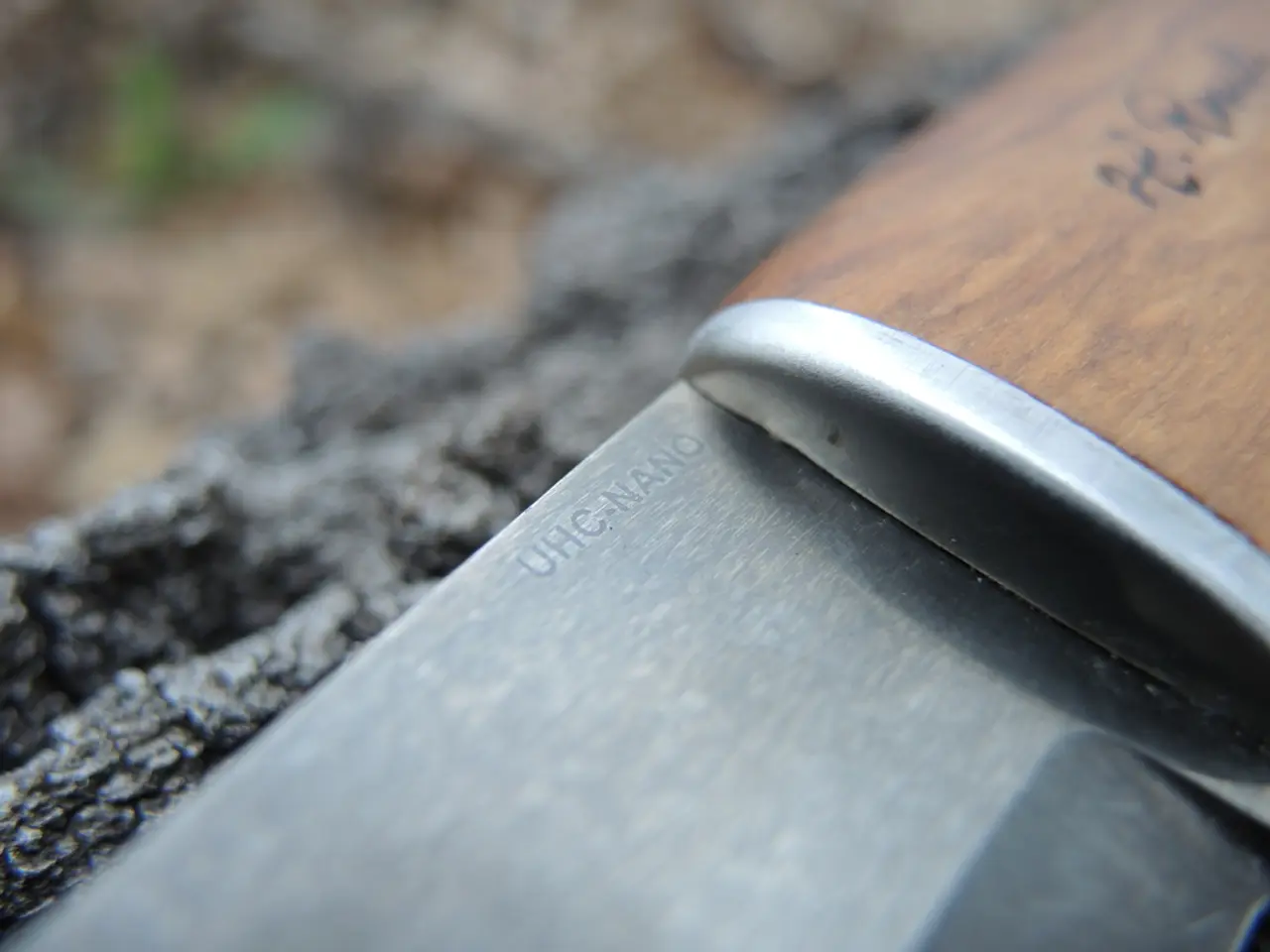 In the image there is a knife on the rock.