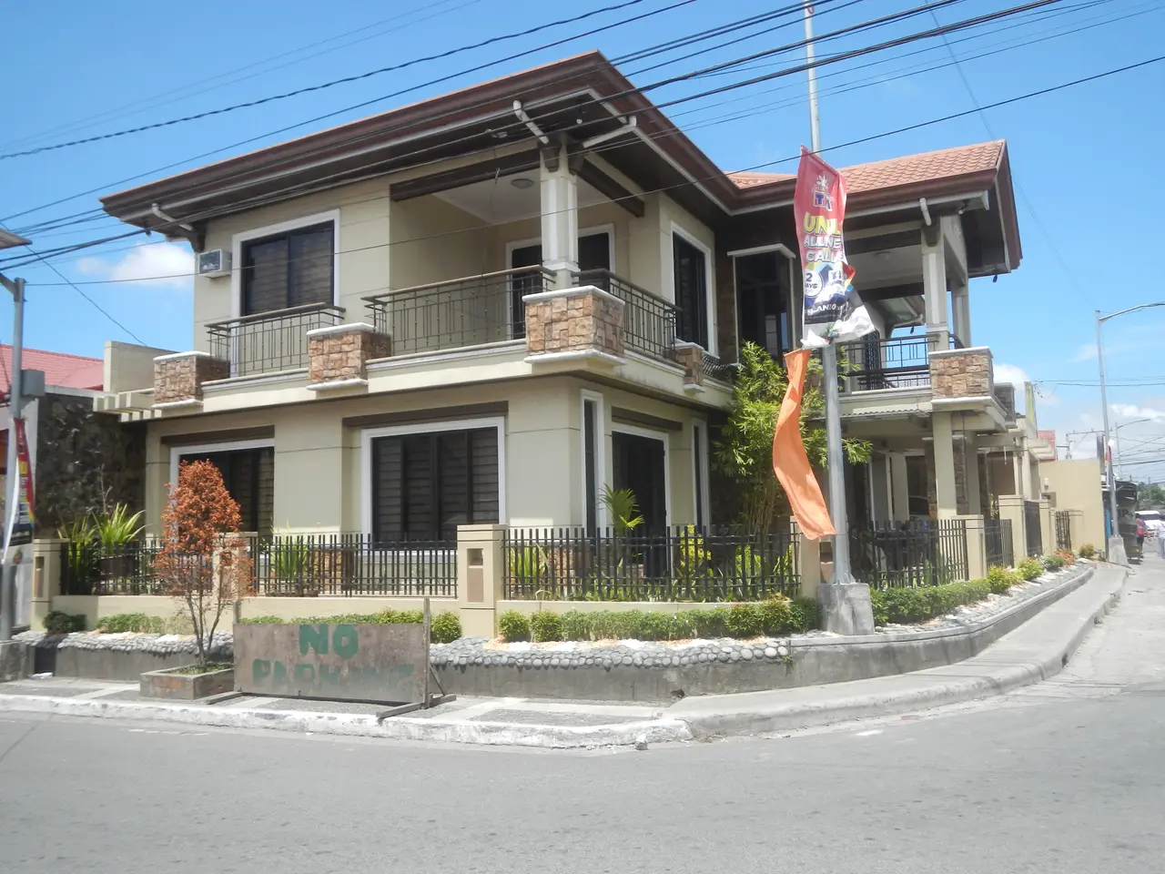 The image shows a house for sale in Imus, Cavite, Philippines. It has windows, railings, pillars...
