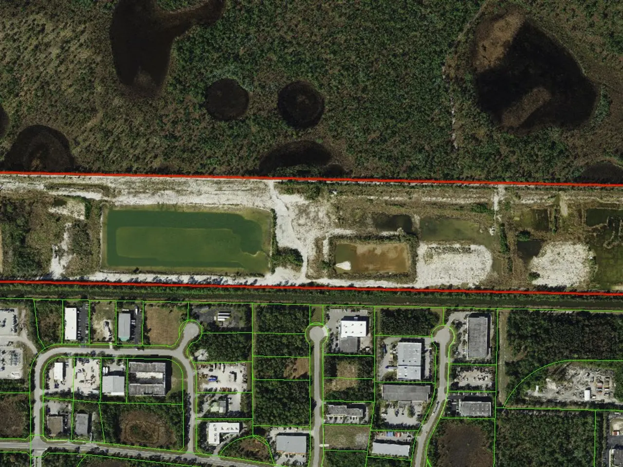 The image shows an aerial view of a large industrial area in the middle of a forest, with...