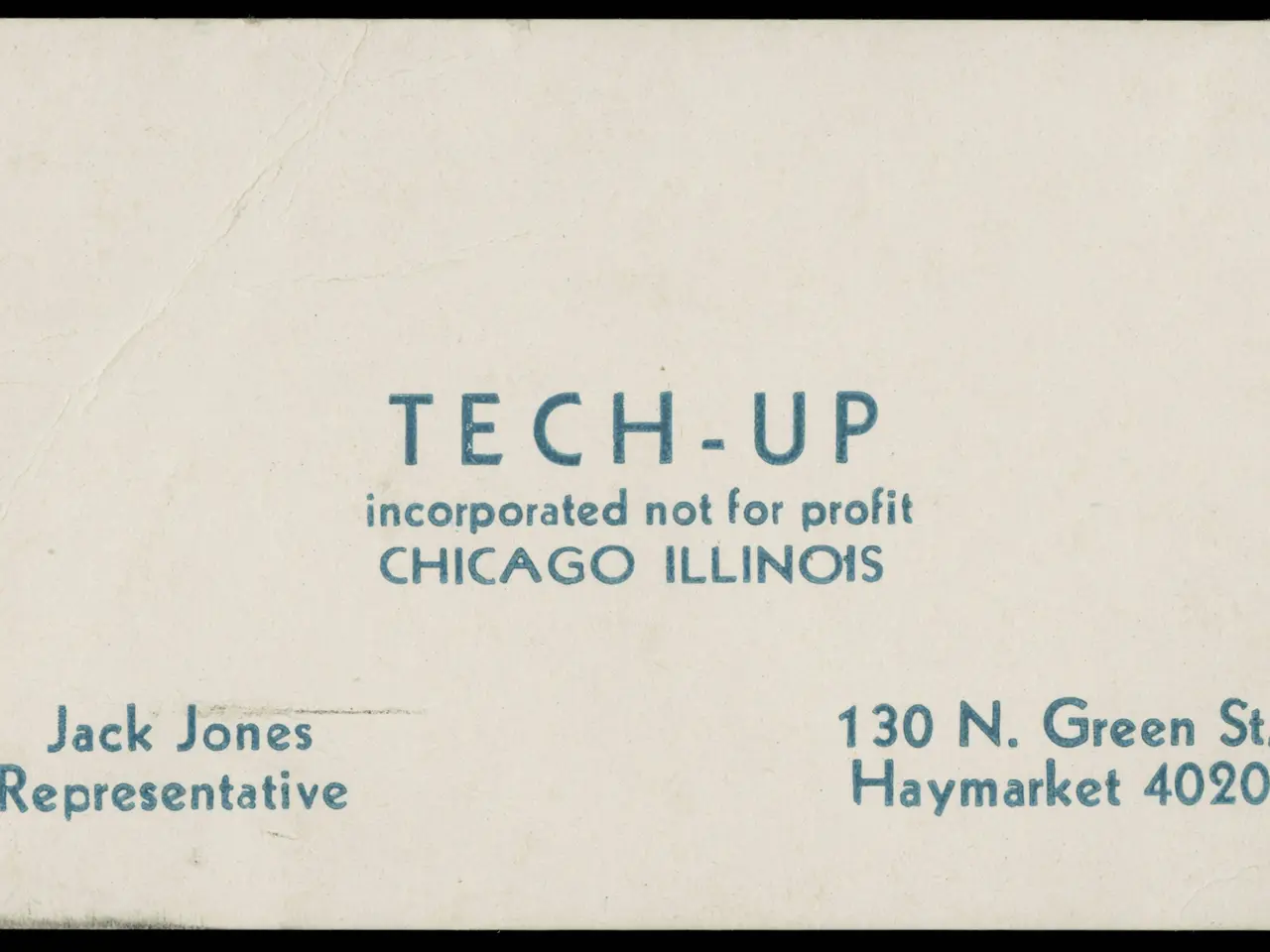 The image shows an old business card with the words "tech-up incorporated not for profit" written...