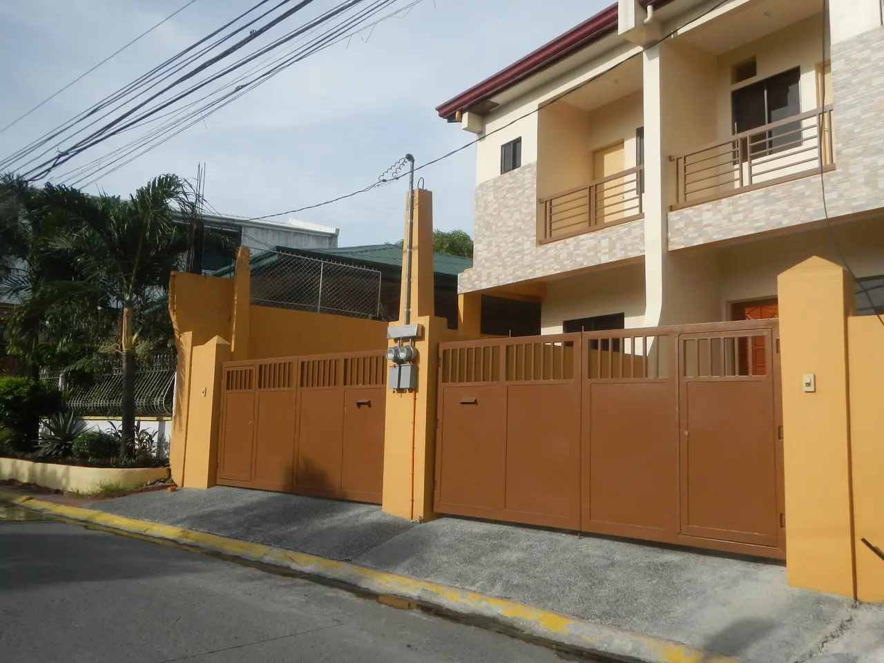The image shows a house for sale in Imus, Cavite, Philippines. It is a two-story building with...