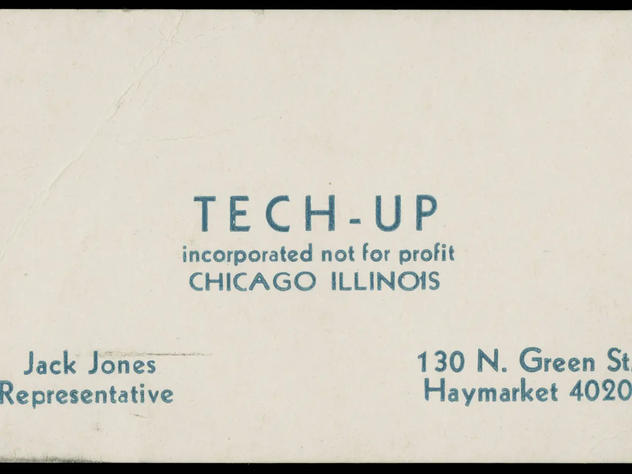 The image shows an old business card with the words "tech-up incorporated not for profit" written...