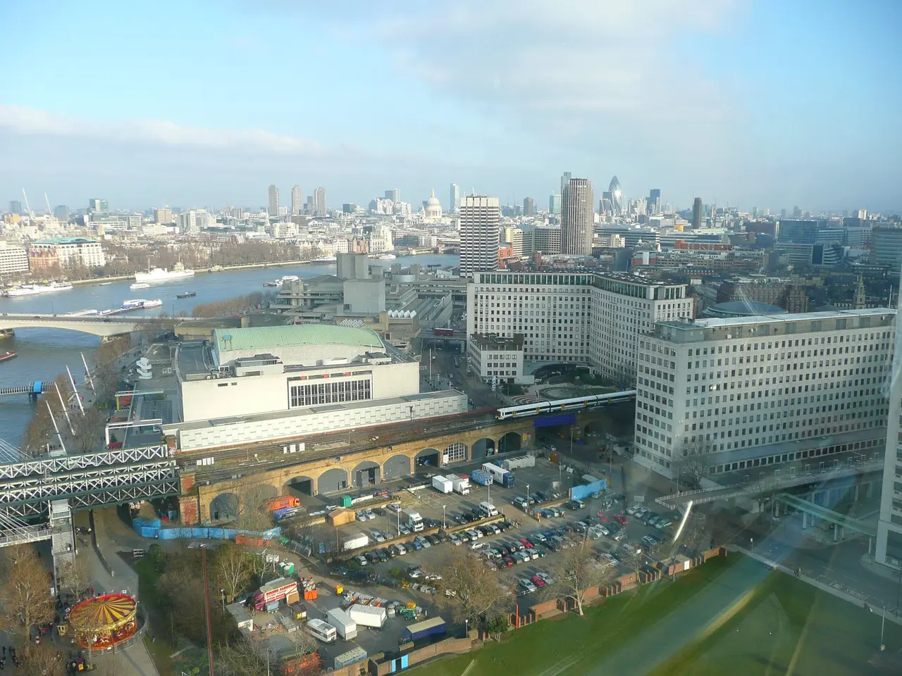 The image shows a view of the city of London from the top of a skyscraper. We can see many...