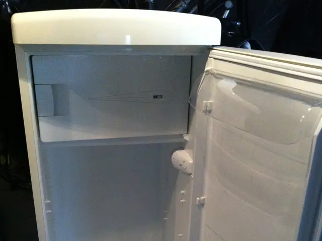 This picture shows a refrigerator on the floor and its door is opened.