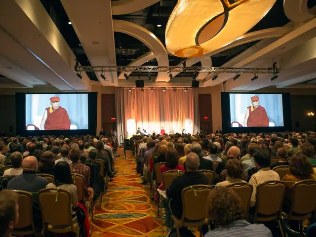 This image is clicked in auditorium. There are two screens one is on the right side and the other...