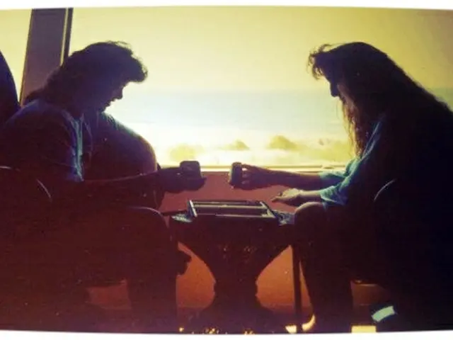 In the a man and a woman are sitting on a chairs.