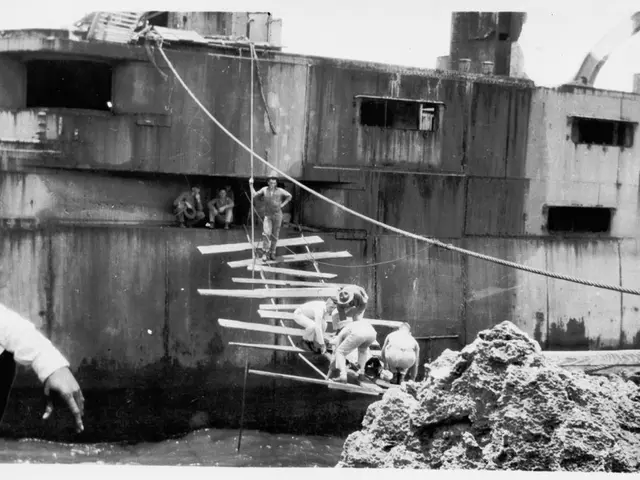 This is a black and white image in which we can see there is a building where people are sitting...