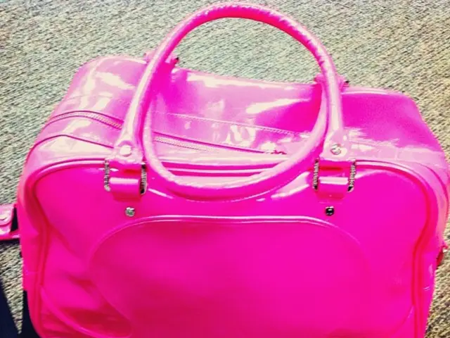 This image is clicked inside the room. There is a man in pink color. Is kept on the floor. At the...