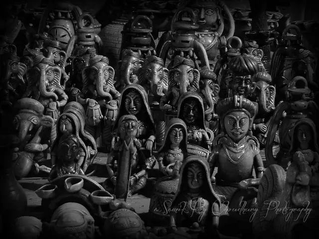 In this image we can see some idols of Ganesha, women and some men.