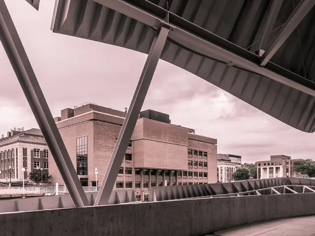 There are buildings in white and brown color. Beside that, we see street lights and an iron...