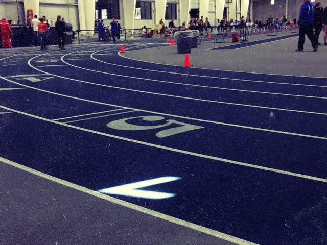 In this picture I can see a track, there are cone bar barricades, those are looking like dustbins,...