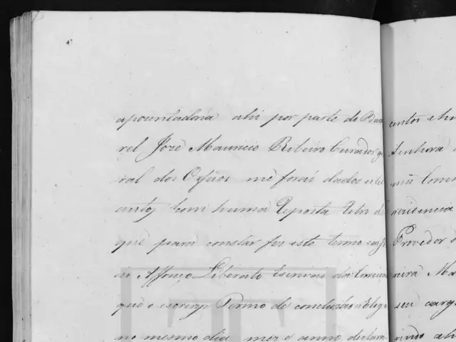 The image shows an open book with handwriting on it and a pen resting on top of it. The book is...