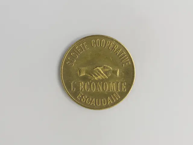 The image shows a gold coin with the words "Societe Cooperative L'Economie Escaudain" written on it...