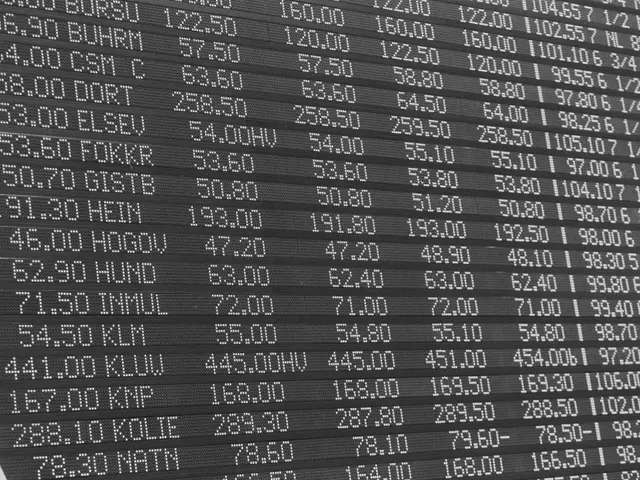 The image shows a black and white photo of an electronic board with numbers and text on it. The...