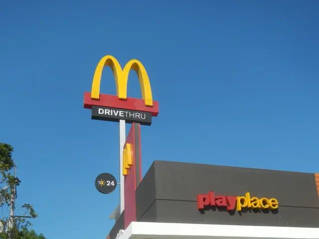 The image shows a McDonald's restaurant with a sign that reads "Playplace" on the side of it,...
