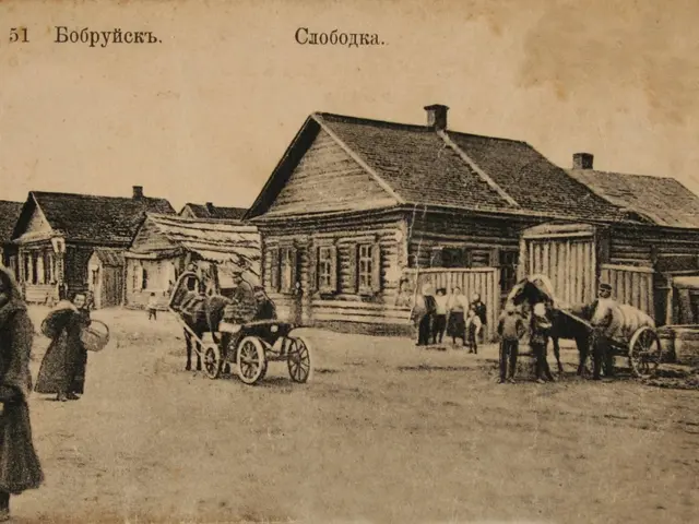 The image shows an old black and white photo of people walking down a street in a village, with...