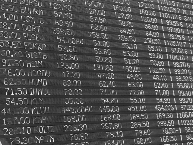 The image shows a black and white photo of an electronic board with numbers and text on it. The...