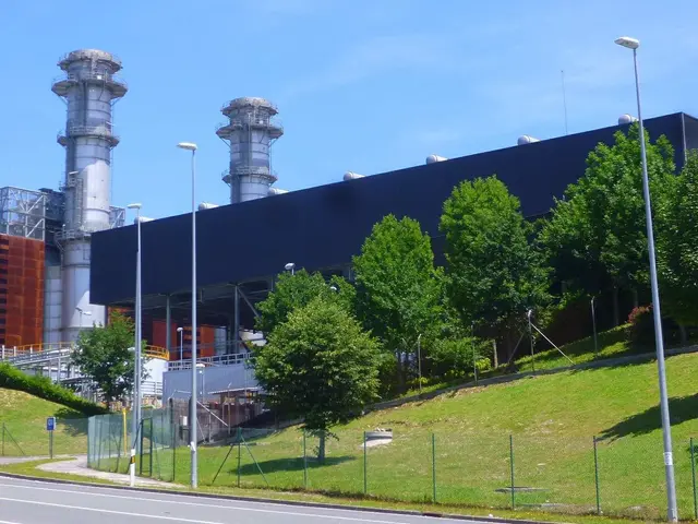 The image shows a large building with a lot of windows on the side of it, surrounded by street...