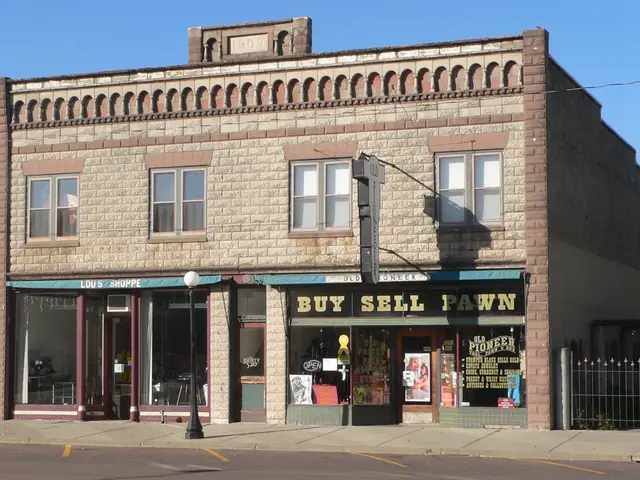 The image shows a building with a sign that reads "Buy Sell Pawn" on the corner of a street,...