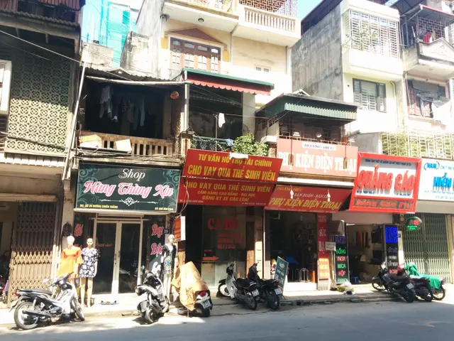 The image shows a bustling street in Ho Chi Minh City, Vietnam, with a variety of buildings,...