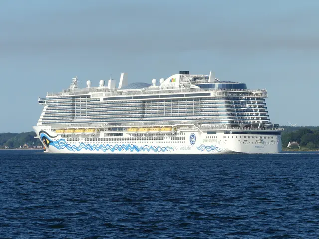 The image shows Royal Caribbean's Allure of the Seas, a large white and blue cruise ship, sailing...
