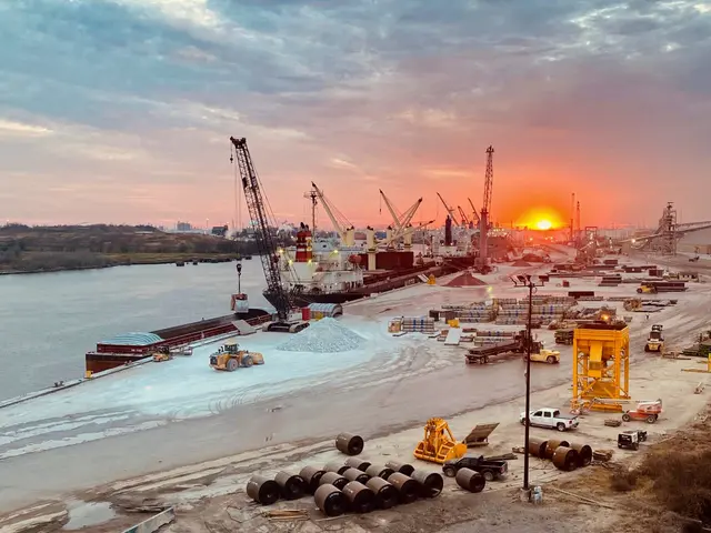 The image shows a large body of water with a lot of construction equipment on it, including...