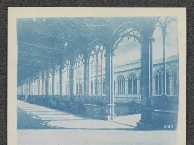 The image shows an old photo of a building with arches and pillars, a floor, and a ceiling. The...