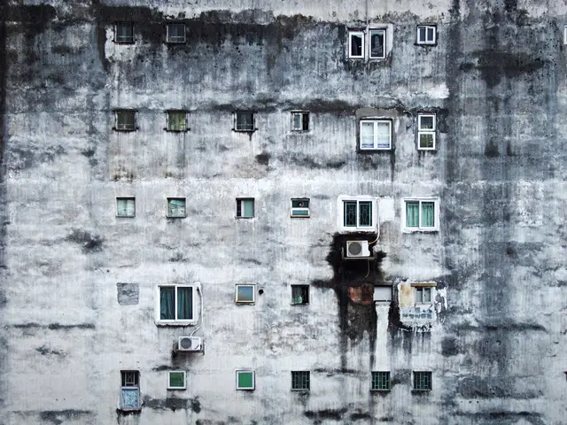 The image shows an old building with many windows and air conditioners attached to the wall. The...