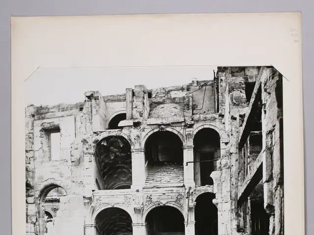 The image shows a black and white photo of an old building on a white surface. The building appears...