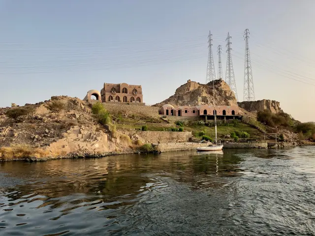 The image shows a boat floating on top of a body of water, surrounded by rocks, plants, trees, and...