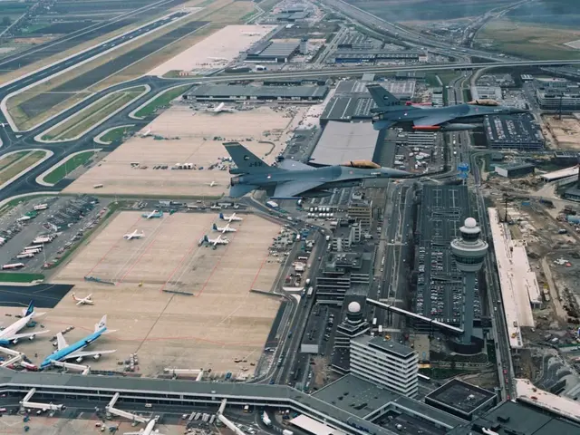 The image shows an aerial view of an airport with several fighter jets parked on the tarmac,...