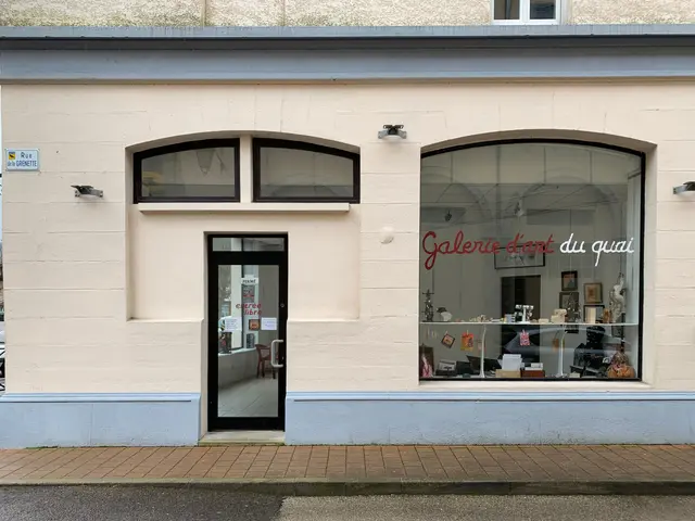 The image shows a building with a glass door and windows, a signboard with text on it, some lights...