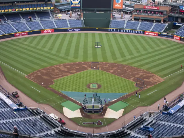 The image shows a baseball stadium filled with lots of people watching a game. There are chairs,...