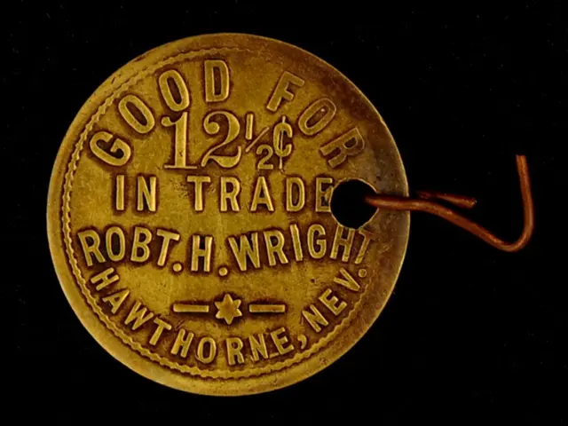 The image shows a gold coin with the words "Good for 12% in Trade" inscribed on it, attached to a...