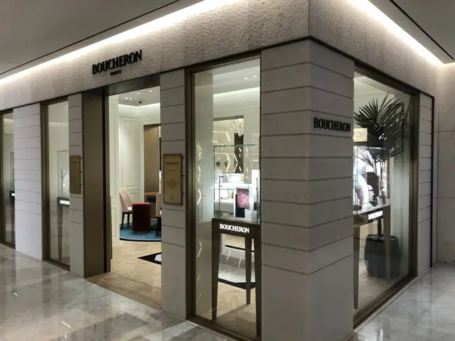 The image shows the entrance to a boutique in a shopping mall, with glass walls and doors, text on...