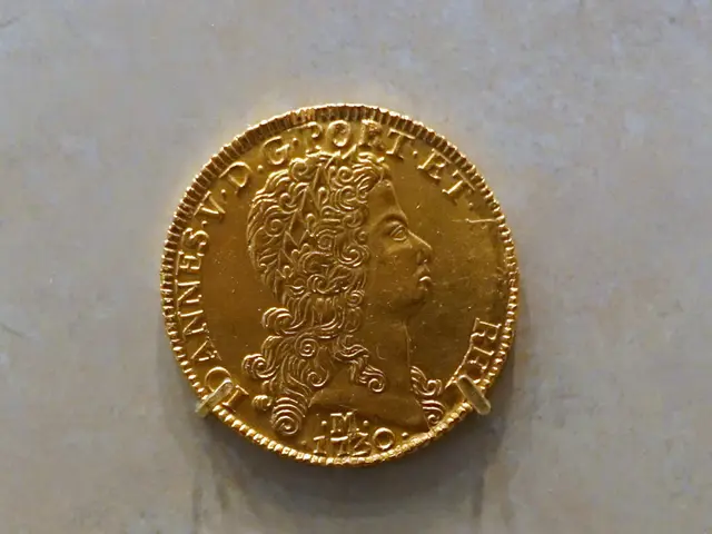 The image shows a gold coin on display in a museum, with the text "Brazil 12,800 Reis 1730"...